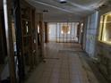Interior view of a home under construction with exposed framing, tile flooring, and boarded windows at 1432 Lemon Bay Dr, Englewood, FL 34223