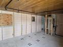 Interior of a room under construction with exposed framing, track lighting, and plywood window coverings at 1432 Lemon Bay Dr, Englewood, FL 34223