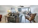 Cozy living room with plush seating, tile floors and sliding doors to a balcony at 14459 River Beach Dr # 129, Port Charlotte, FL 33953