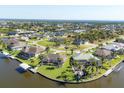 Areal view of charming community with waterfront homes, canals, palm trees, and beautiful Florida sunshine at 15690 Viscount Cir, Port Charlotte, FL 33981