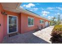 View of the home's front entrance, featuring a brick exterior and tiled walkway at 1694 Harbor W Cir, Largo, FL 33770