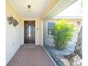 Welcoming front entrance with tiled porch and decorative details at 1957 Arkansas Ave, Englewood, FL 34224