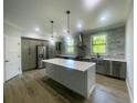 Modern kitchen with stainless steel appliances and a large center island at 220 Jennifer Dr, Rotonda West, FL 33947