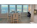Bright dining area with water views through large windows perfect for waterfront lifestyle at 2405 N Beach Rd # 10, Englewood, FL 34223