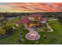 Aerial view of the backyard featuring a pool, fire pit, and manicured lawn at 3700 Como St, Port Charlotte, FL 33948