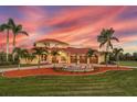 Beautiful home boasting a circular driveway, three-car garage, and mature palm trees at 3700 Como St, Port Charlotte, FL 33948
