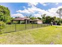 Charming home with a well-manicured lawn and decorative fence, adding to the curb appeal at 4238 Golfair Ln, North Port, FL 34288