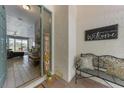 Inviting foyer with tile floors and a 'Welcome' sign, bench, and glimpse into the living area at 4308 Summertree Rd, Venice, FL 34293