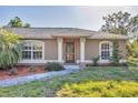 Inviting front entrance with a decorative glass door and well-manicured landscaping at 6345 Bodmin Ln, North Port, FL 34291
