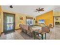 Cozy living room featuring tile floors, ample seating, and a decorative ceiling fan at 6345 Bodmin Ln, North Port, FL 34291