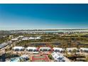 Aerial view showcases the location of the condo complex to the bay in a serene waterfront community at 6800 Placida Rd # 152, Englewood, FL 34224