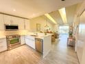 Modern kitchen featuring stainless steel appliances, quartz countertops, and an island at 6800 Placida Rd # 272, Englewood, FL 34224