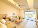 Comfortable living room with a ceiling fan, natural light, and sliding glass doors to the balcony at 6800 Placida Rd # 272, Englewood, FL 34224