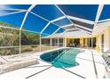 Relaxing screened-in pool area with lounge chairs and an outdoor dining space for entertaining at 7328 Yardley St, Englewood, FL 34224
