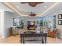 Inviting living room with recessed lighting, ceiling fans, comfortable seating, and views of the outdoors through large windows at 9 Peekins Cove Dr, Boca Grande, FL 33921