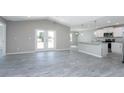 Bright living area boasts modern floors and seamless access to the kitchen with its breakfast bar at 12218 Edwards Rd, Port Charlotte, FL 33981