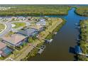 Beautiful waterfront homes on a canal offer private docks, lush landscaping, and screened pools at 14564 Gaspar Loop, Port Charlotte, FL 33981