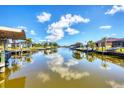 Scenic view of the canal showcasing calm waters and boat docks with covered boat lifts amidst beautiful homes at 14810 Ingraham Blvd, Port Charlotte, FL 33981
