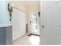 Foyer featuring tile floors, a glass front door, and a white closet at 20231 Lagente Cir, Venice, FL 34293
