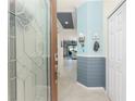 Bright foyer with a decorative glass door and views into the living area at 20231 Lagente Cir, Venice, FL 34293