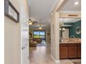 Inviting entryway with tile flooring, and views of the living room and kitchen at 20279 Lagente Cir, Venice, FL 34293
