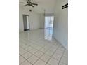 Bright living room featuring tile flooring, ceiling fan, and sliding glass doors to the outdoor area at 2259 Lee Ter, Port Charlotte, FL 33952