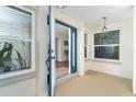 Open blue front door showcasing the entry with sidelight windows and a welcoming interior view at 235 Caddy Rd, Rotonda West, FL 33947
