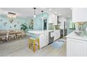 Open concept kitchen with breakfast bar, sleek appliances, and a bright, airy feel at 2955 N Beach Rd # D123, Englewood, FL 34223