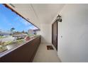 Open porch with front door, showing tile roof, landscaping and sunny blue skies at 311 Garvin St # 209C, Punta Gorda, FL 33950