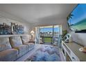 Cozy living room with a balcony offering waterfront views and comfortable furnishings at 311 Garvin St # 209C, Punta Gorda, FL 33950