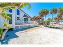 Charming beach house featuring a white picket fence, spacious deck, and beautiful landscaping at 4078 N Beach Rd, Englewood, FL 34223