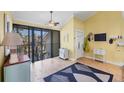 A bedroom featuring a sliding glass door to a balcony, and decorated with a ceiling fan and decorative accessories at 5000 Gasparilla Rd # 41B, Boca Grande, FL 33921