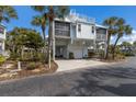 Beautiful elevated home with lush landscaping, garage, and rooftop deck in a tropical setting at 5000 Gasparilla Rd # Vh37, Boca Grande, FL 33921