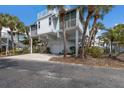 Coastal home with palm trees, a garage, and a rooftop deck offers a relaxed beach lifestyle at 5000 Gasparilla Rd # Vh37, Boca Grande, FL 33921