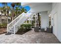 Outdoor patio with seating area and stairs leading to the main level of the home at 5000 Gasparilla Rd # Vh37, Boca Grande, FL 33921