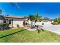 Charming home with lush lawn, pretty landscaping with palm trees, and a two-car garage, perfect for Florida living at 544 Foxwood Blvd, Englewood, FL 34223