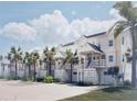 Charming white townhomes feature covered entrances, lush tropical landscaping and ample parking at 5800 Gulf Shores Dr # 33, Boca Grande, FL 33921