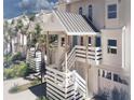 Close up of white townhome featuring private entrances, manicured landscaping, and coastal charm at 5800 Gulf Shores Dr # 33, Boca Grande, FL 33921