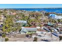 Stunning aerial view of waterfront home with mature landscaping and clear blue ocean view at 6035 Manasota Key Rd, Englewood, FL 34223