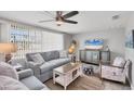 Beautiful living room with a large window, comfortable seating, and beach decor at 6035 Manasota Key Rd, Englewood, FL 34223