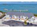 Exterior view of residences with balconies and parking, showcasing a well-maintained complex near the water at 6040 Boca Grande Cswy # A2, Boca Grande, FL 33921