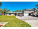 Charming two-story home featuring an oversized driveway, two-car garage, and parking for your RV at 698 & West W Perry St, Englewood, FL 34223