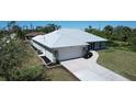 Charming one-story home with a new metal roof, attached two-car garage, and well-manicured landscaping at 7499 Clearwater St, Englewood, FL 34224