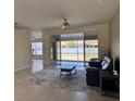 Open living space featuring tiled flooring, fan, and sliding glass doors to the backyard at 7499 Clearwater St, Englewood, FL 34224