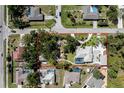 Aerial view of the property showing the lot, home, pool, detached garage and surrounding neighborhood at 820 Bayshore Dr, Englewood, FL 34223