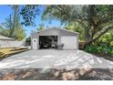 Spacious detached garage with two bays and high ceilings perfect for car enthusiasts or hobbyists at 820 Bayshore Dr, Englewood, FL 34223