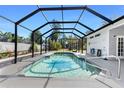 Screened-in pool area with a sparkling pool, perfect for relaxation and entertaining at 820 Bayshore Dr, Englewood, FL 34223