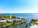 Aerial view of waterfront home with swimming pool, dock, and boating access at 840 Park Rd, Englewood, FL 34223