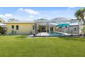 Inviting backyard with screened pool, patio area and well maintained lawn at 840 Park Rd, Englewood, FL 34223