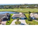 Stunning single-story home featuring a well-manicured lawn and golf course views at 977 N Doral Ln, Venice, FL 34293